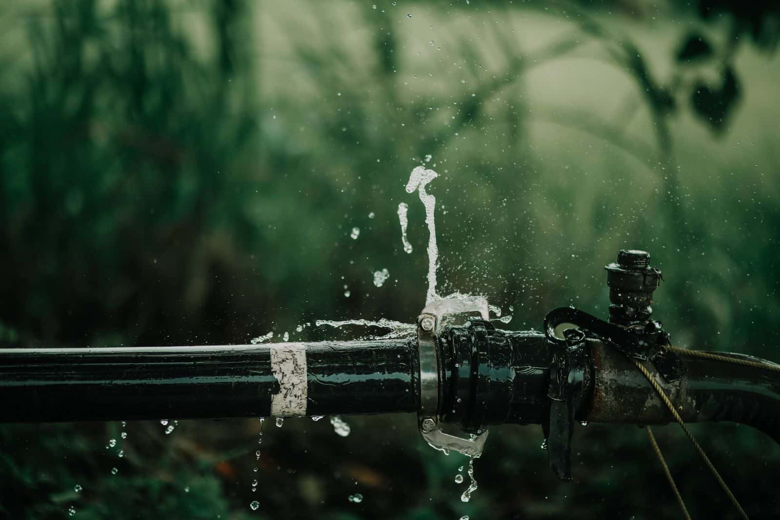 Water spraying from a burst pipe fitting